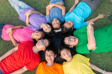 Group of student's friendship and team work lay down on the grass relaxing