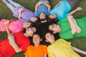 Group of student's friendship and team work lay down on the grass relaxing