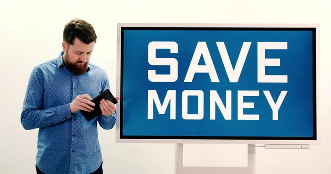 Bearded Man, first looking at his wallet, than at a sign stating "Save Money", looking confident.