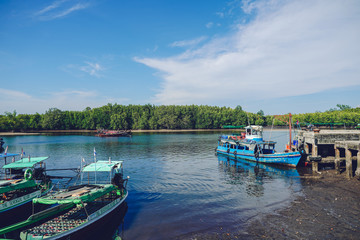 Naklejka premium Old wooden boat carrying goods at the pier