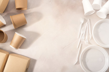 Biodegradable and plastic tableware on light background. Environmental protection. Secondary processing. The concept of zero waste.