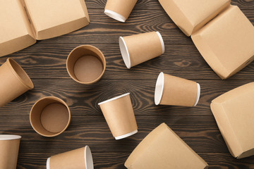 Biodegradable tableware on wooden background. Environmental protection. Secondary processing. The concept of zero waste.