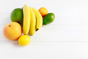 Various fruits on white wooden background