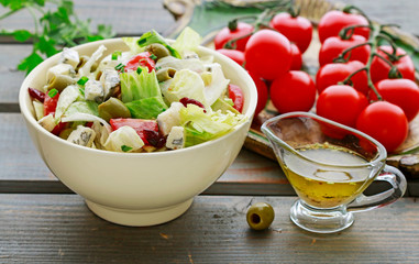 Vegetable salad with tomato, cheese and olives.