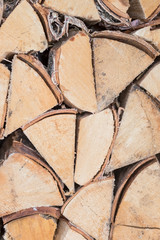 Preparation of firewood for the winter. firewood background, Stacks of firewood in the forest. Pile of firewood. Wood decor. Texture and abstract image.