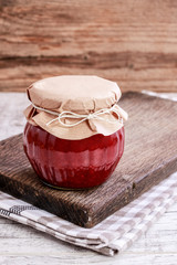 Glass jar with red jam. Homemade food. Sweet autumn dessert.