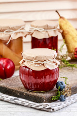 Glass jar with red jam. Homemade food. Sweet autumn dessert.