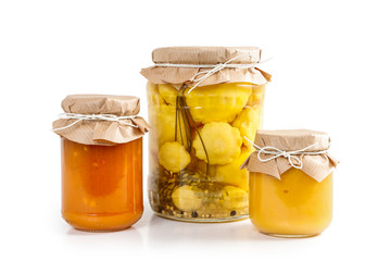 Pickled vegetables and colorful jams in glass jars