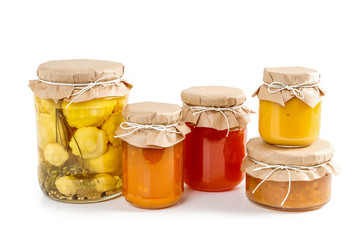 Pickled vegetables and colorful jams in glass jars