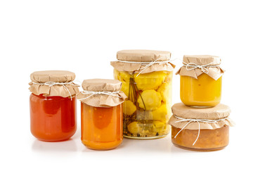 Pickled vegetables and colorful jams in glass jars
