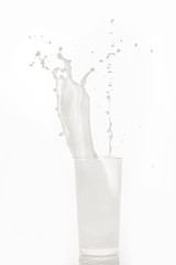 Glass cup with milk on a white background.