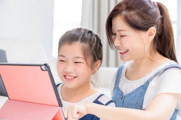 Mom and daughter use tablet