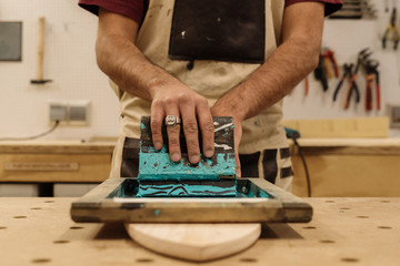 Hands putting logotype on desk