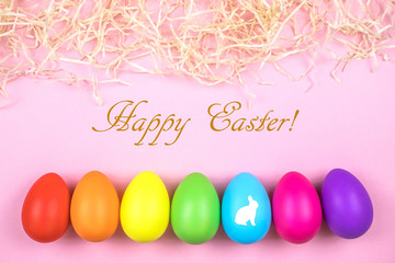 Colored Easter eggs on pink background. Flatlay.
