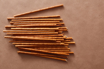 Crispy bread straw on brown paper background