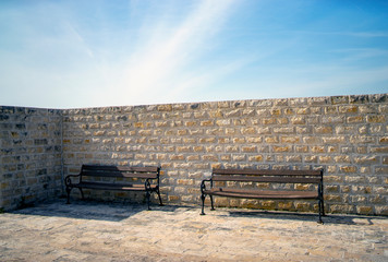 Wooden bench near the stone wall, Mediterranean, Croatian, summer, sunny