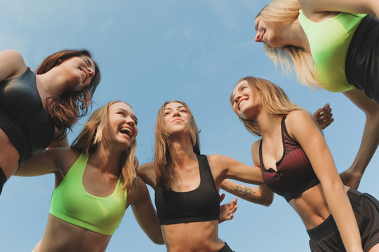 a team of female athletes discuss and talk