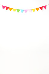 Colorful party flags hanging on white wall  background, birthday, anniversary, celebrate event, festival greeting card background