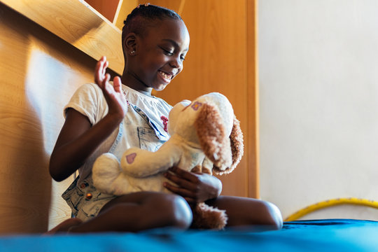 Portrait of cute girl playing with stuffed