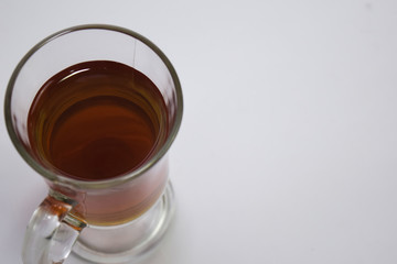 Black tea in a glass cup isolated on a white background