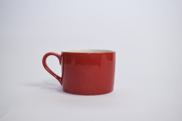 Close up hot cappuccino coffee in a red cup isolated on a white background