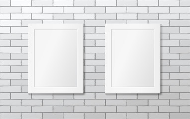 Two white picture frames on a white brick wall. Vector mock up