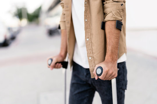 Close Up Of Young Man Using Crutches