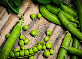 fresh green pea legumes on a wooden table