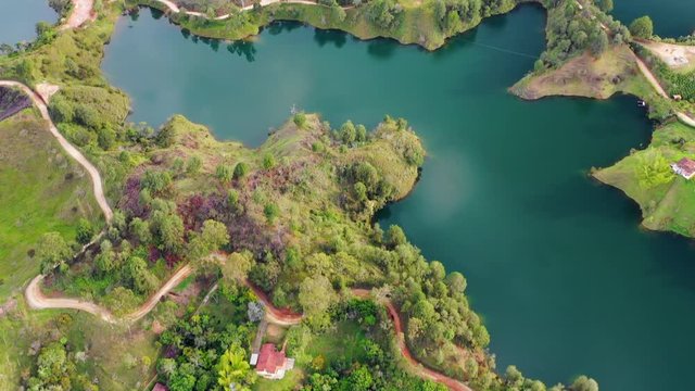 Aerial: View of the Guatape Lake and the Rock of Guatape in Guatape, Columbia