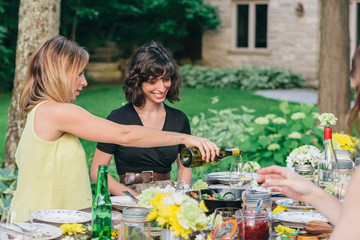 Pouring white wine for a friend