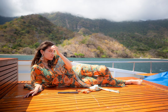 Young Woman With dress lie down on the deck
