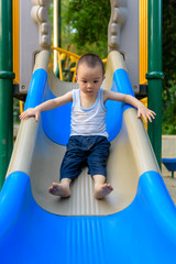 Asian kid on slide