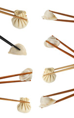 Set of chopsticks with dumplings on white background