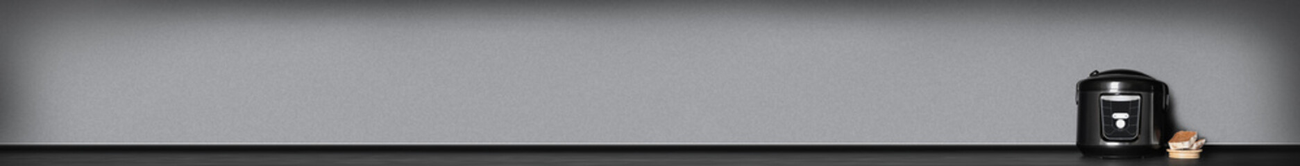 Modern electric multi cooker on table against color background. Space for text