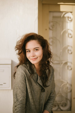 Portrait of a young beautiful woman walking in old town