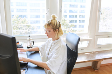 Hardworking woman typing on her laptop