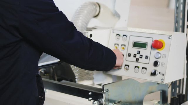 Engineer setting up automatic edge bander machine