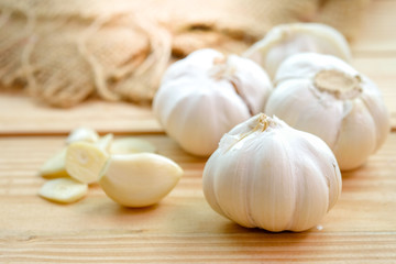 Garlic bulb head and cloves on wooden floor, Herbs and spices are important in cooking