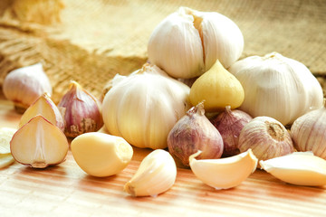 Garlic bulb head and cloves on wooden floor, Herbs and spices are important in cooking