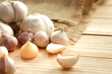 Garlic bulb head and cloves on wooden floor, Herbs and spices are important in cooking