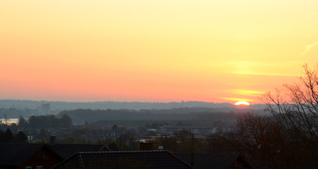 Sunrise in a landscape with urban foeground.