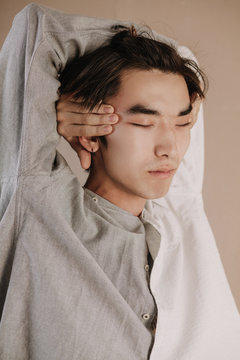 Asian guy embracing head