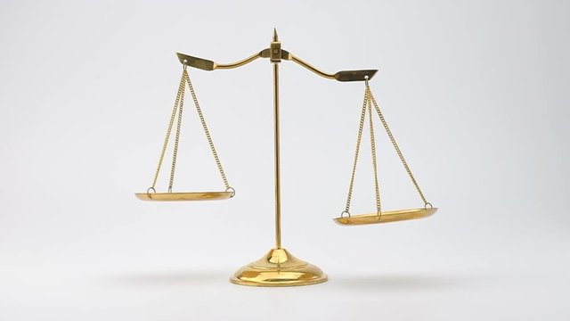 Slow motion of Gold brass balance scale isolated on white background.