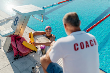 Woman swimmer with her coach