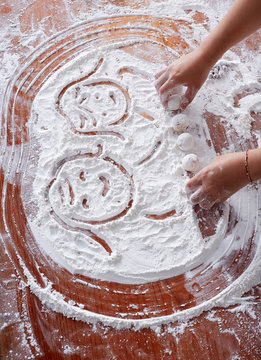 Closeup Asian child's hand, happy to make Chinese dessert rice dumpling at home.