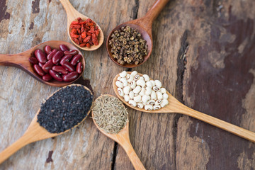 Cereal grains , seeds, beans,spices on wooden background.