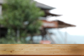 Empty dark wooden table in front of abstract blurred bokeh background of restaurant . can be used for display or montage your products.Mock up for space.