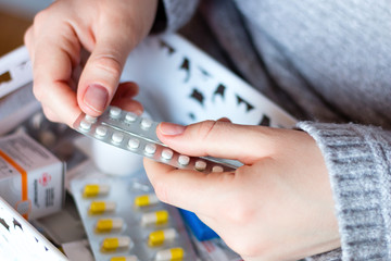 young woman and birth control pills contraceptive from a first aid kit