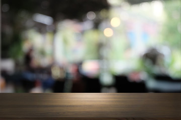 Empty dark wooden table in front of abstract blurred bokeh background of restaurant . can be used for display or montage your products.Mock up for space.