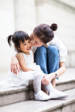 Happy Little Asian Toddler Girl With Her Mother Outdoor